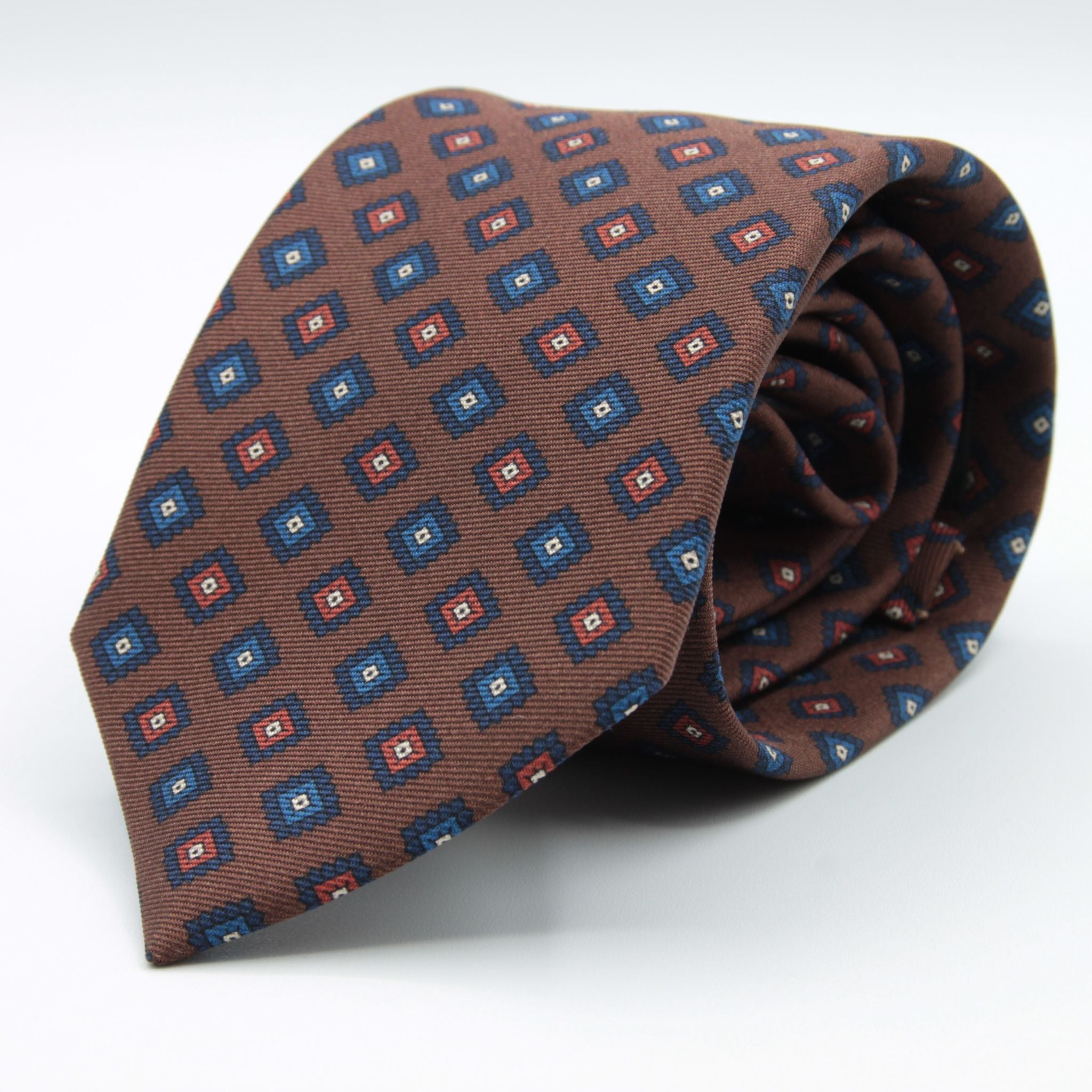 Holliday &amp; Brown for Cruciani &amp; Bella
100% printed Madder Silk
Self Tipped
Brown, Navy Blue and Rust medallions motif Tie
Handmade in Italy
8 cm x 150 cm
#8957