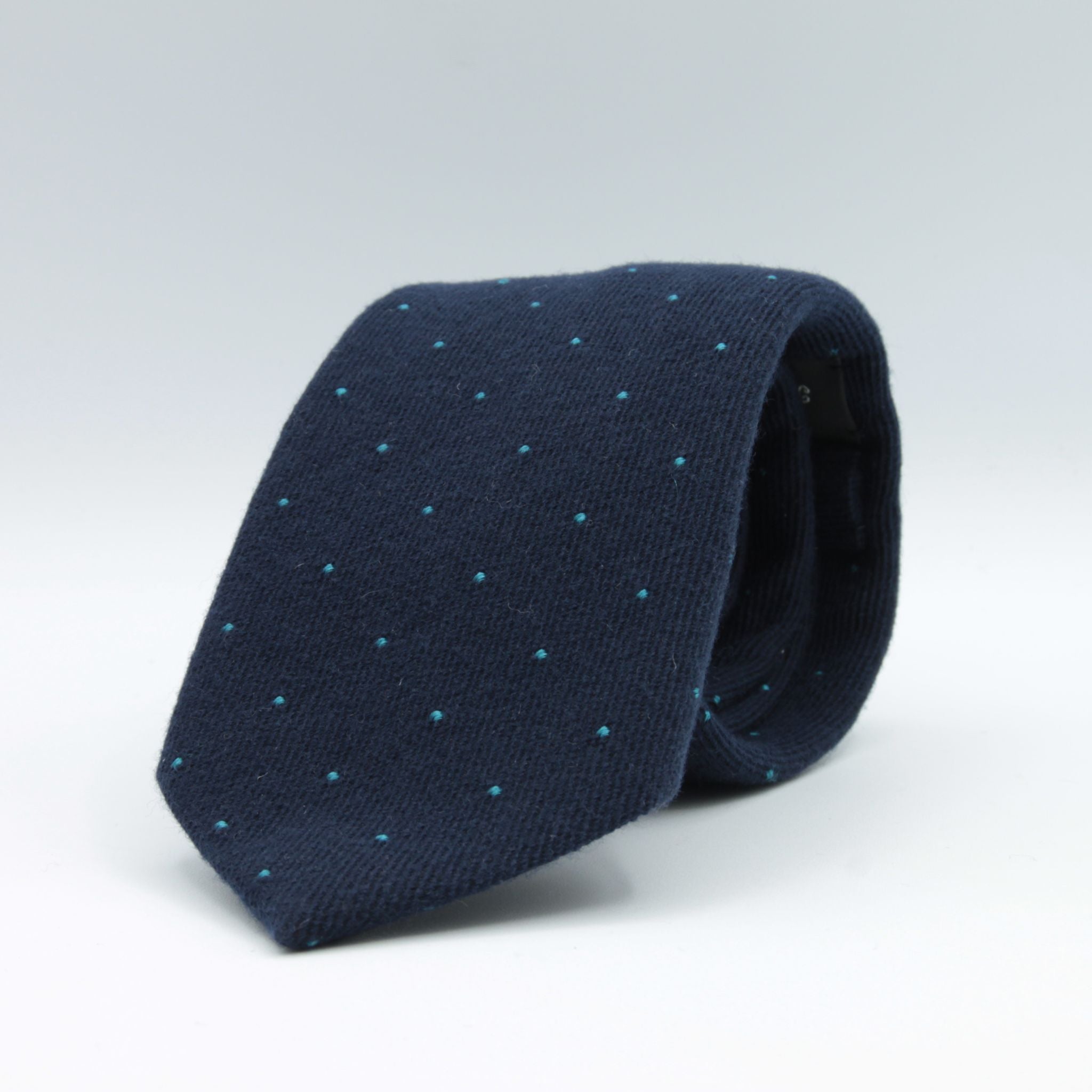 Holliday &amp; Brown for Cruciani &amp; Bella
85% Wool - 15% Silk
Tipped

Navy Blue and Torquoise micro-dots motif tie
Handmade in Italy

8 cm x 150 cm
#8982