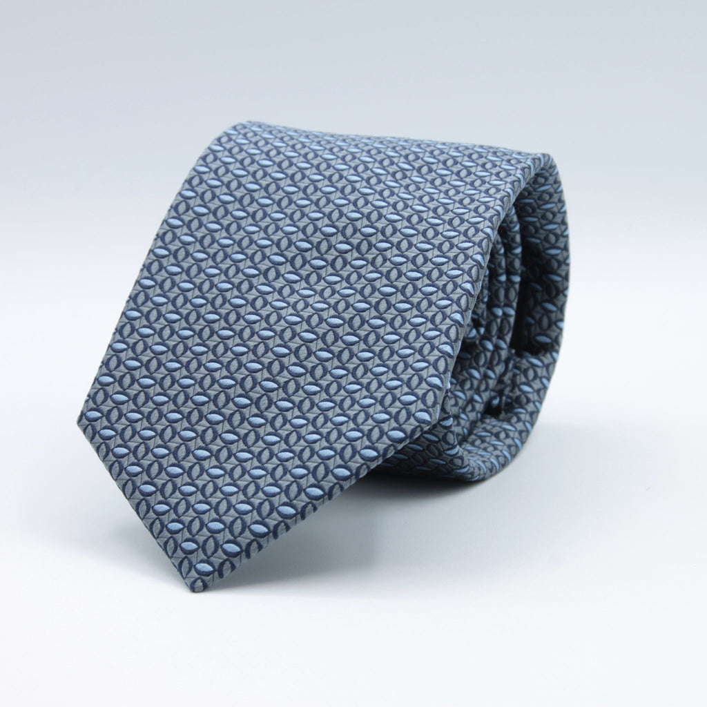 Holliday &amp; Brown for Cruciani &amp; Bella
100%&nbsp;Woven Jacquard Silk
Tipped

Grey and Light Blue motif tie
Handmade in Italy

8 cm x 150 cm
#9071