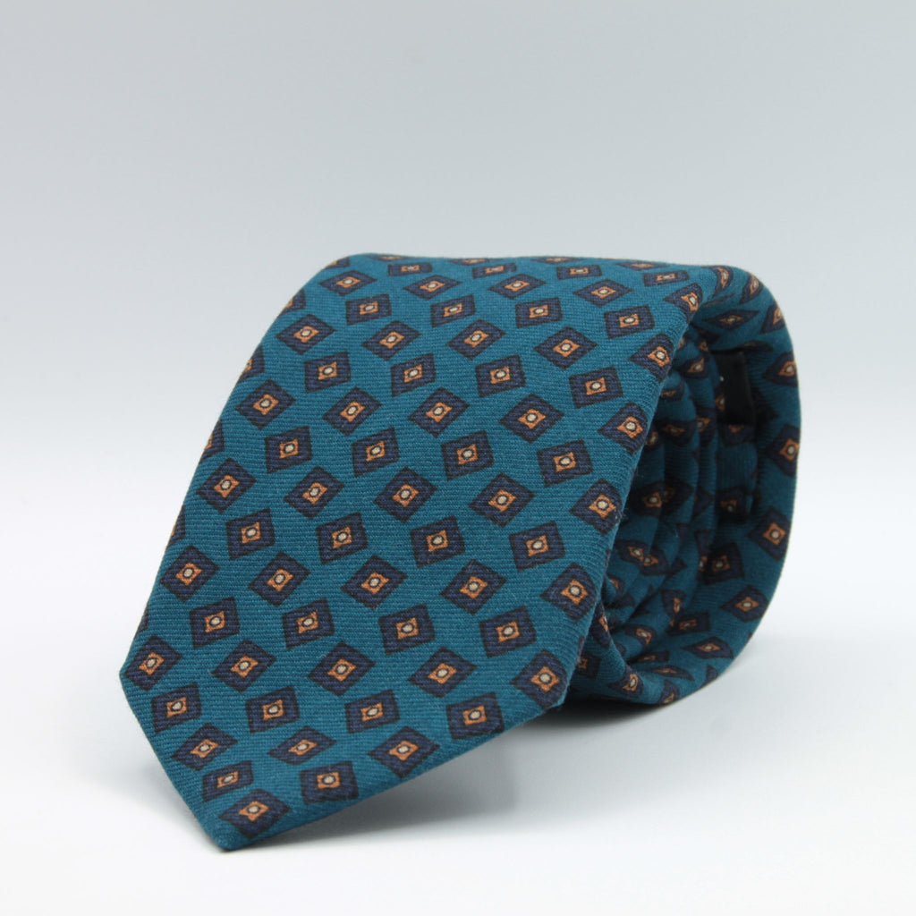 Holliday &amp; Brown for Cruciani &amp; Bella
100% Printed Wool
Self-Tipped

Dark Turquoise, Royal Blue and Brown Color motif tie
Handmade in Italy

8 cm x 150 cm
#8984