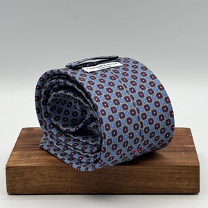 Cruciani &amp; Bella
100% Printed Silk&nbsp;
Tipped
Grey, Light Blue, Blue and Red Motif Tie
Handmade in Italy
8,5 cm x 148 cm
New Old Stock
