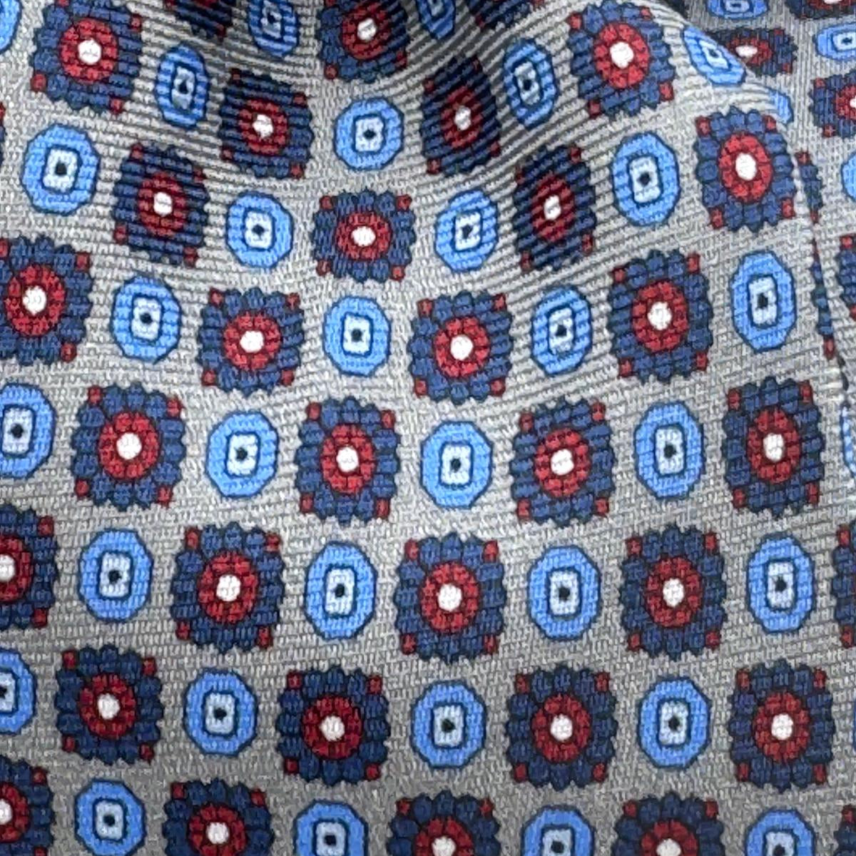 Cruciani &amp; Bella
100% Printed Silk&nbsp;
Tipped
Grey, Light Blue, Blue and Red Motif Tie
Handmade in Italy
8,5 cm x 148 cm
New Old Stock