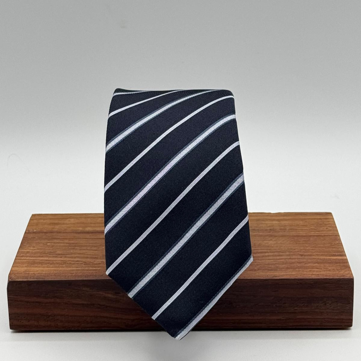 Cruciani &amp; Bella
100% Silk&nbsp;
Woven Jacquard&nbsp;
Self Tipped
Dark Bleu, Grey and Light Bleu Stripes Tie
Handmade in Italy
New Old Stock
7 cm x 150 cm