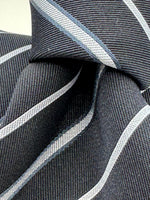 Cruciani &amp; Bella
100% Silk&nbsp;
Woven Jacquard&nbsp;
Self Tipped
Dark Bleu, Grey and Light Bleu Stripes Tie
Handmade in Italy
New Old Stock
7 cm x 150 cm