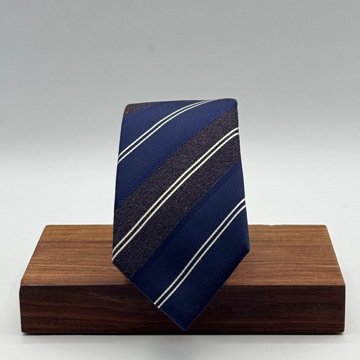 Cruciani &amp; Bella
100% Silk&nbsp;
Woven Jaquard
Tipped Tie
Blue, Brown and White Stripes
Handmade in Italy
7 cm x 148 cm
New Old Stock
