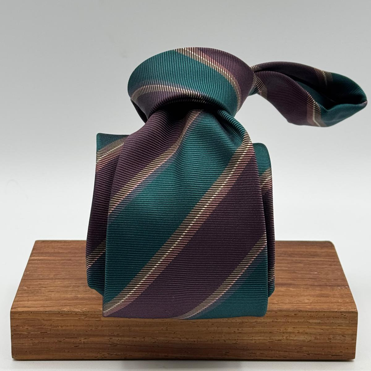 Cruciani &amp; Bella
100% Silk&nbsp;
Woven Jaquard
Self Tipped&nbsp;
Red Wine, Green, Brown and Beige Stripes
Handmade in Italy
9 cm x 148 cm
New Old Stock