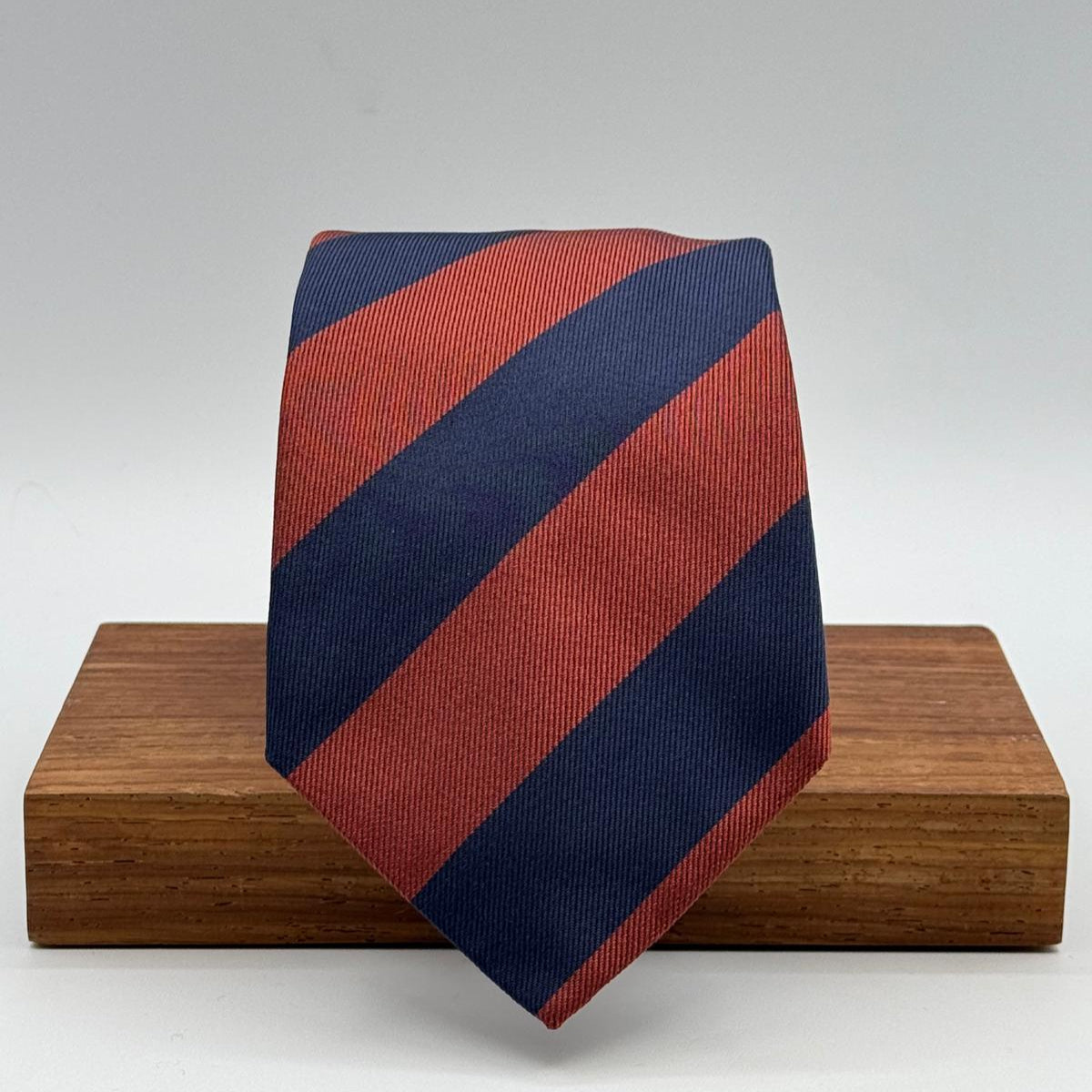 Cruciani &amp; Bella
100% Silk&nbsp;
Woven Jaquard
Self Tipped&nbsp;
Blue and Rust Stripes
Handmade in Italy
9 cm x 148 cm
New Old Stock