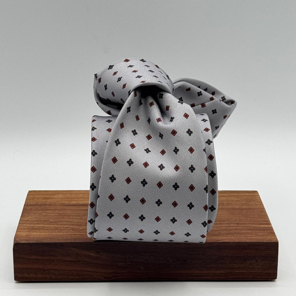 Cruciani &amp; Bella
100% Printed Silk&nbsp;
Tipped
Grey, Red and Blue Motif Tie
Handmade in Italy
8 cm x 148 cm
New Old Stock